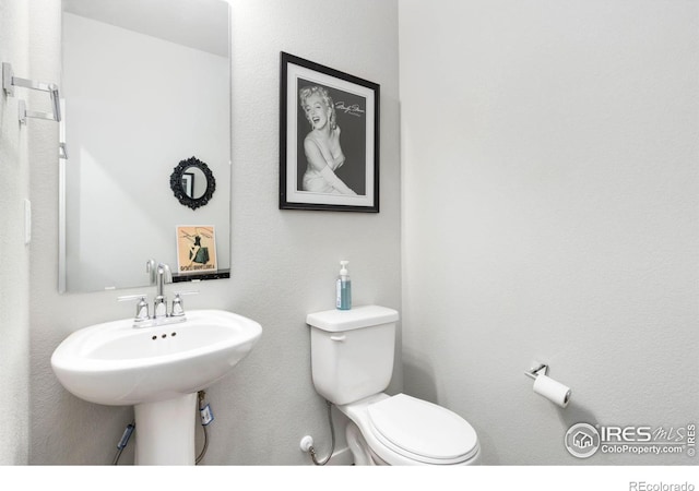 bathroom featuring toilet and sink