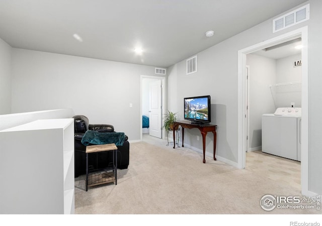 interior space featuring washer / dryer and light colored carpet