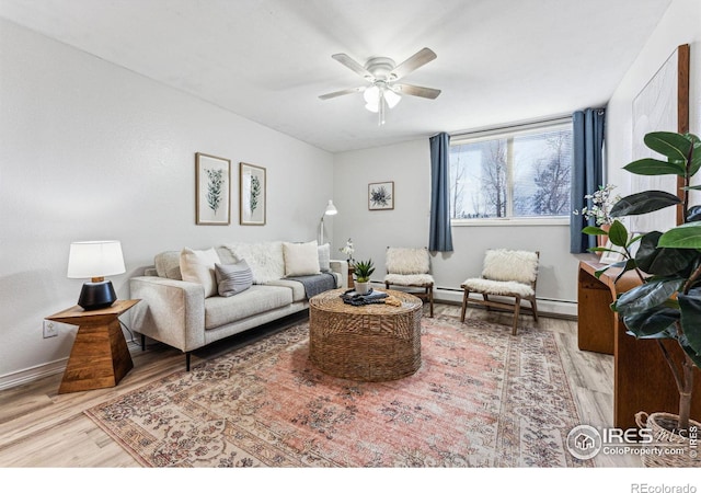 living room with light hardwood / wood-style floors, ceiling fan, and a baseboard heating unit