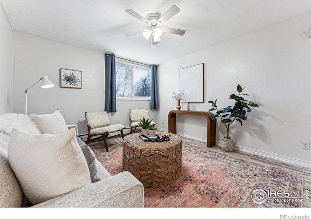 living room with wood-type flooring and ceiling fan