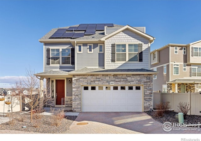 view of front of house with solar panels and a garage