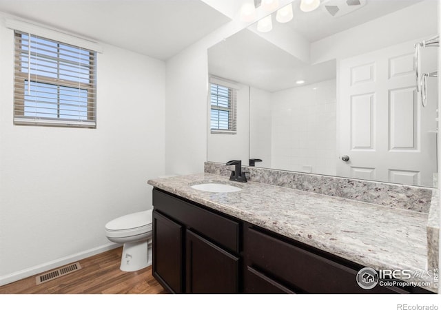 bathroom with hardwood / wood-style floors, vanity, and toilet