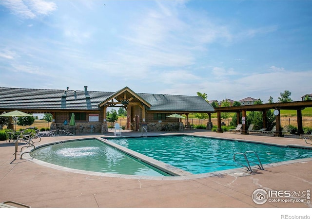 view of swimming pool with a patio area