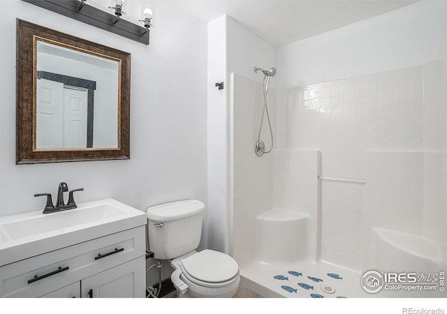 bathroom featuring a shower, vanity, and toilet