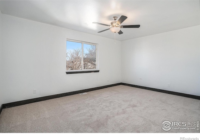 spare room with light colored carpet and ceiling fan