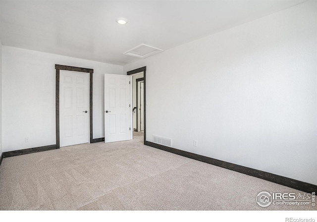 unfurnished bedroom featuring light carpet