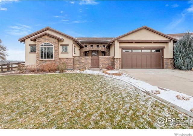 view of front of property featuring a garage and a front lawn