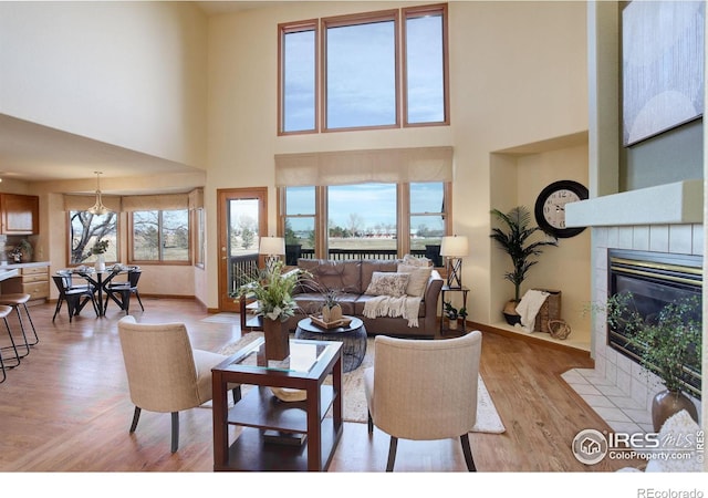 living room featuring a fireplace and a towering ceiling