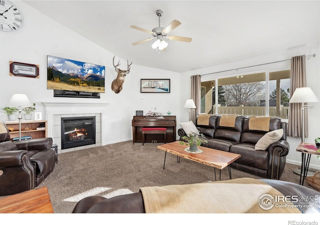 carpeted living room featuring a fireplace, vaulted ceiling, and ceiling fan