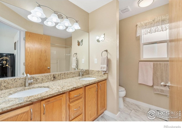 bathroom featuring vanity and toilet