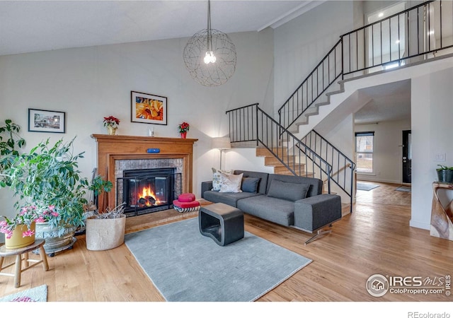 living room with hardwood / wood-style floors and a high ceiling