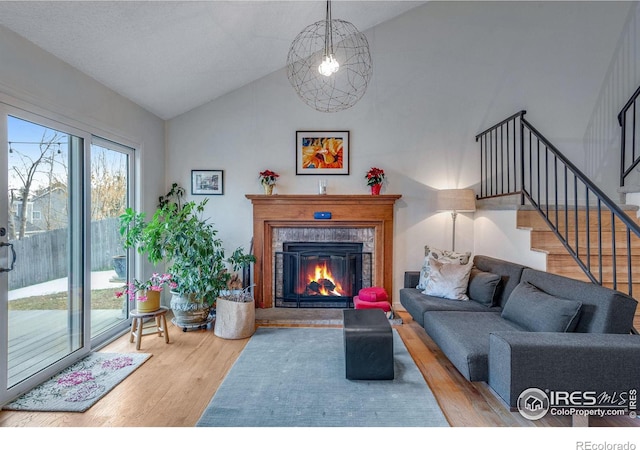 living room with hardwood / wood-style floors and vaulted ceiling