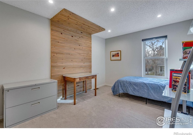 carpeted bedroom with a textured ceiling