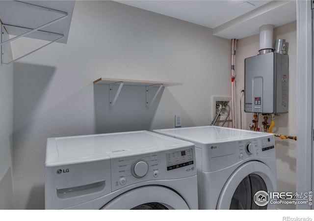 laundry room with washing machine and dryer and tankless water heater