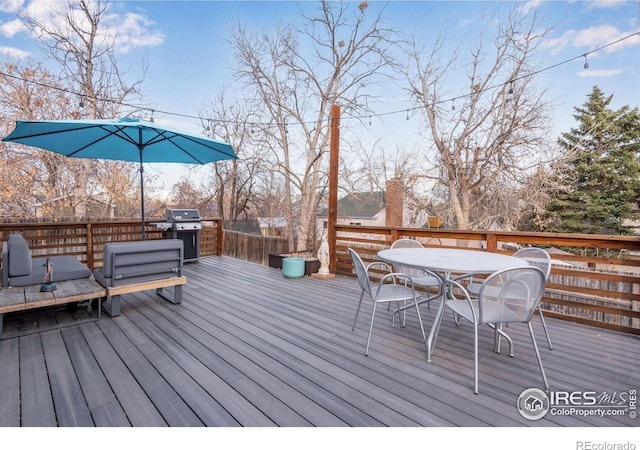 wooden deck with a grill