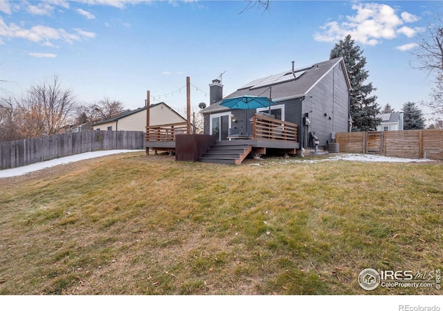 view of yard featuring cooling unit and a deck