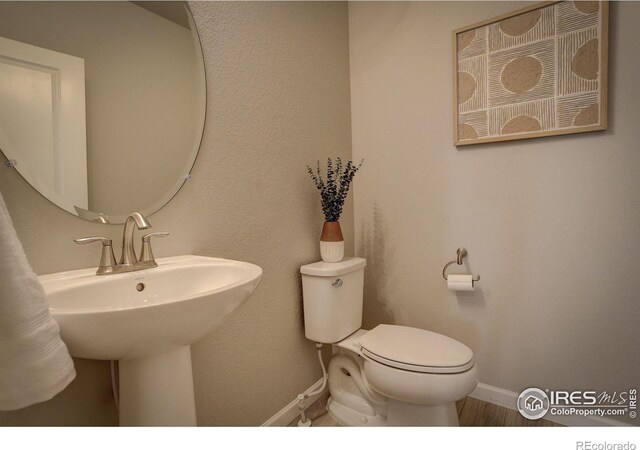 bathroom featuring sink and toilet