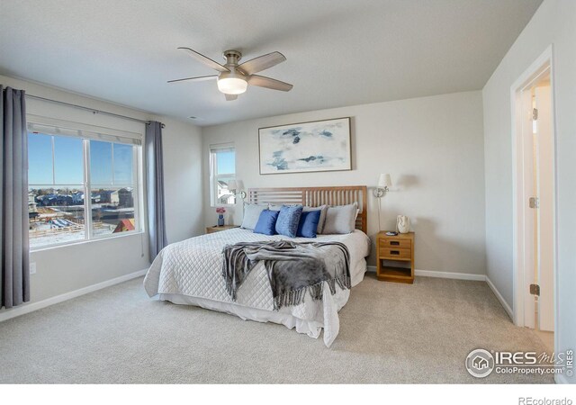 carpeted bedroom with ceiling fan