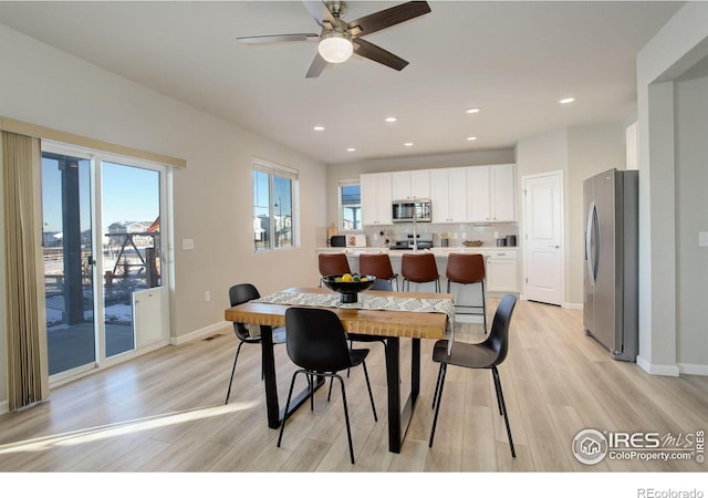 dining space featuring light wood-type flooring and ceiling fan