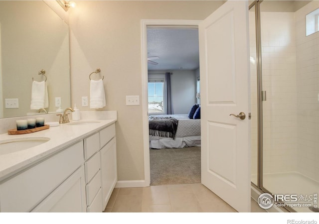 bathroom featuring vanity, tile patterned floors, and a shower with door