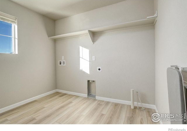 laundry room featuring a healthy amount of sunlight, hookup for an electric dryer, hookup for a washing machine, and light hardwood / wood-style flooring