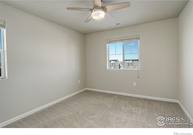 carpeted empty room featuring ceiling fan