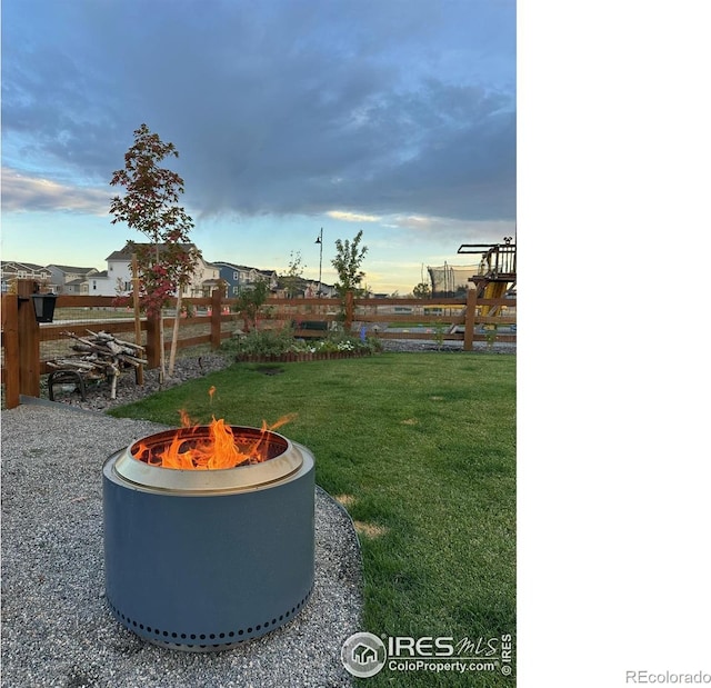 yard at dusk with an outdoor fire pit