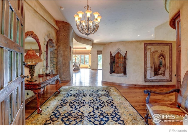 entryway featuring a chandelier and light hardwood / wood-style flooring