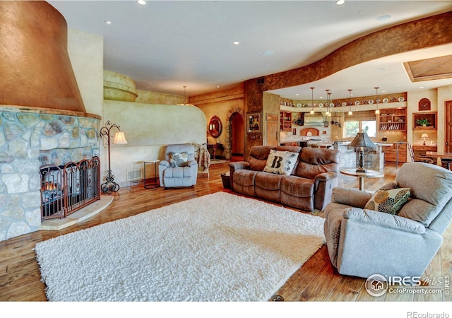 living room with a fireplace and light hardwood / wood-style flooring