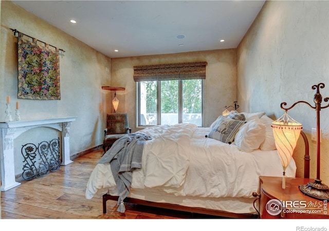 bedroom with access to exterior and light hardwood / wood-style floors