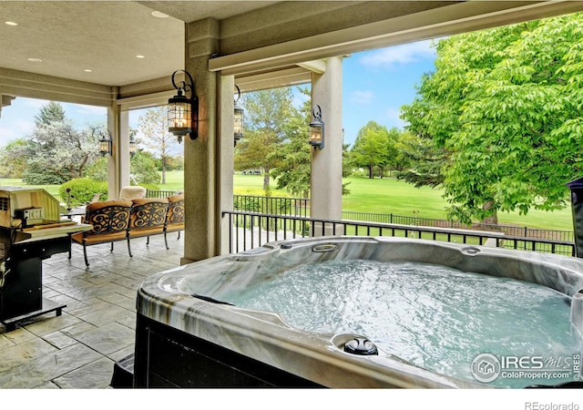 sunroom featuring a hot tub