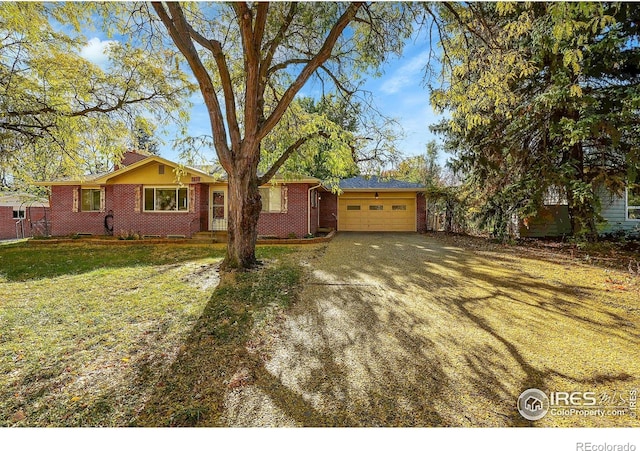 single story home with a garage and a front lawn