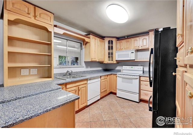 kitchen with light brown cabinetry, sink, light stone counters, light tile patterned floors, and white appliances