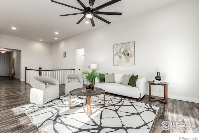 living room featuring ceiling fan and dark hardwood / wood-style flooring