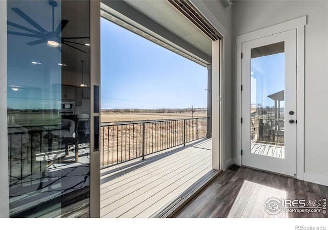 interior space with a rural view and dark hardwood / wood-style flooring