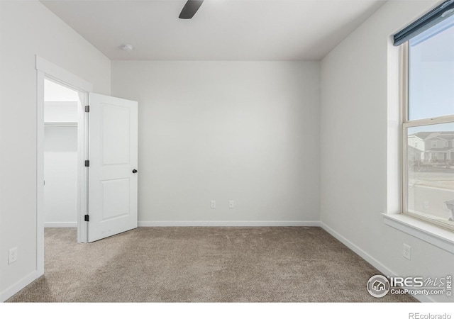 carpeted empty room with ceiling fan