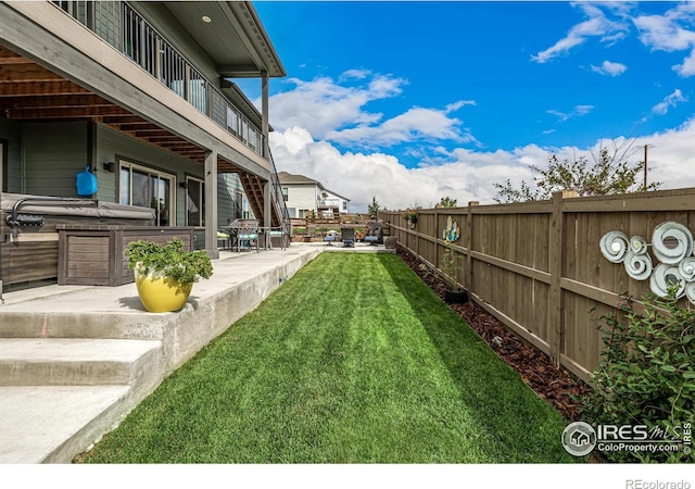 view of yard featuring a patio and a hot tub