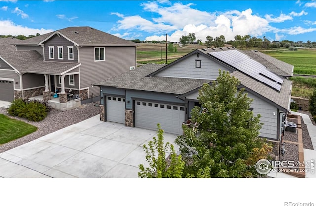 view of front facade with solar panels and a garage