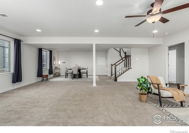 interior space with light colored carpet and ceiling fan