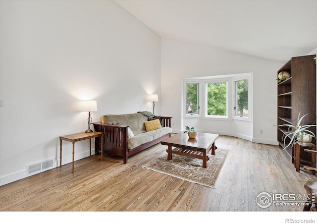 living room featuring light hardwood / wood-style flooring and lofted ceiling