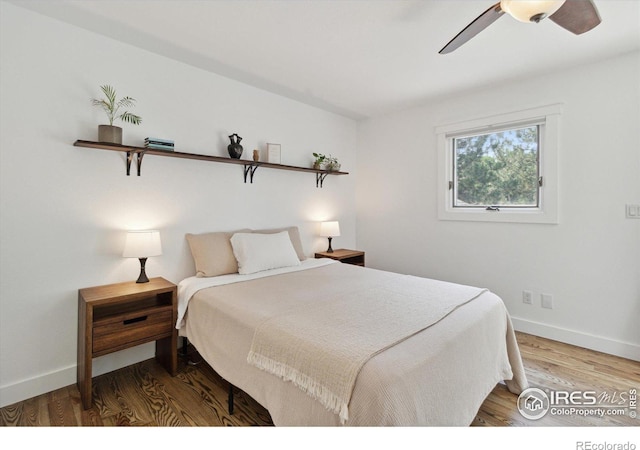 bedroom featuring hardwood / wood-style flooring and ceiling fan