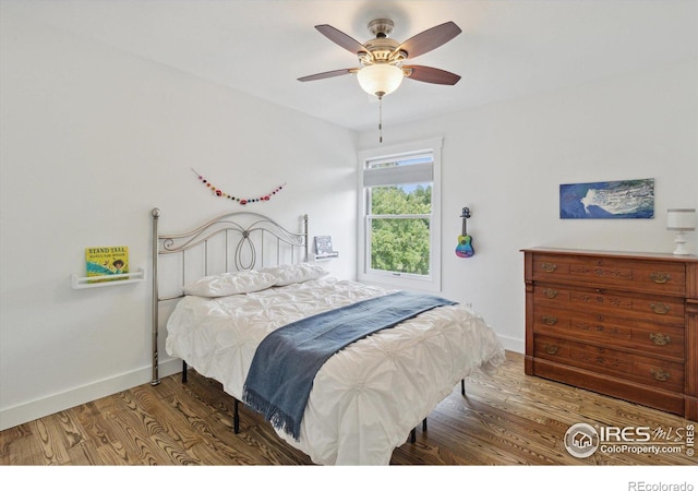 bedroom with hardwood / wood-style flooring and ceiling fan