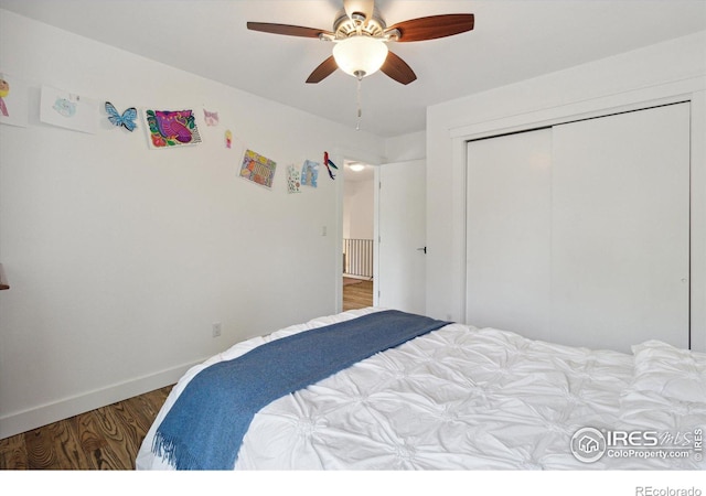 bedroom with a closet, ceiling fan, and dark hardwood / wood-style floors