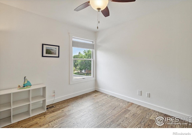 empty room featuring ceiling fan and light hardwood / wood-style floors