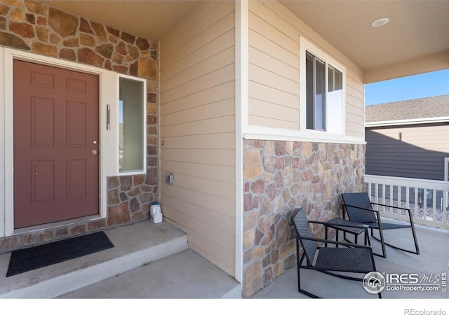 doorway to property featuring covered porch