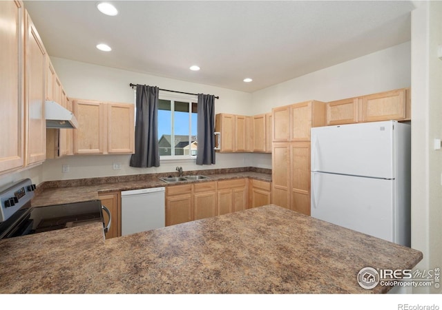 kitchen with light brown cabinets, white appliances, and sink