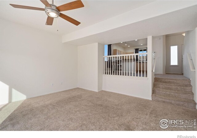 carpeted empty room featuring ceiling fan