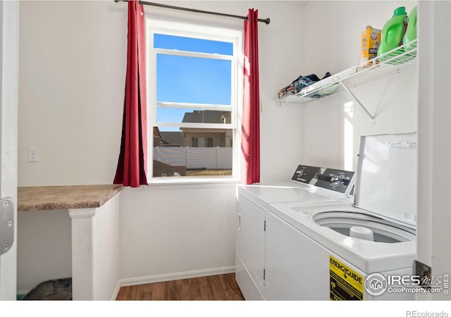 washroom featuring dark hardwood / wood-style flooring and washing machine and clothes dryer