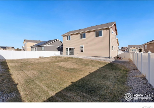 rear view of house featuring a yard