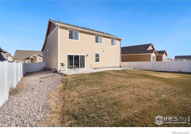 rear view of house featuring cooling unit, a yard, and a patio